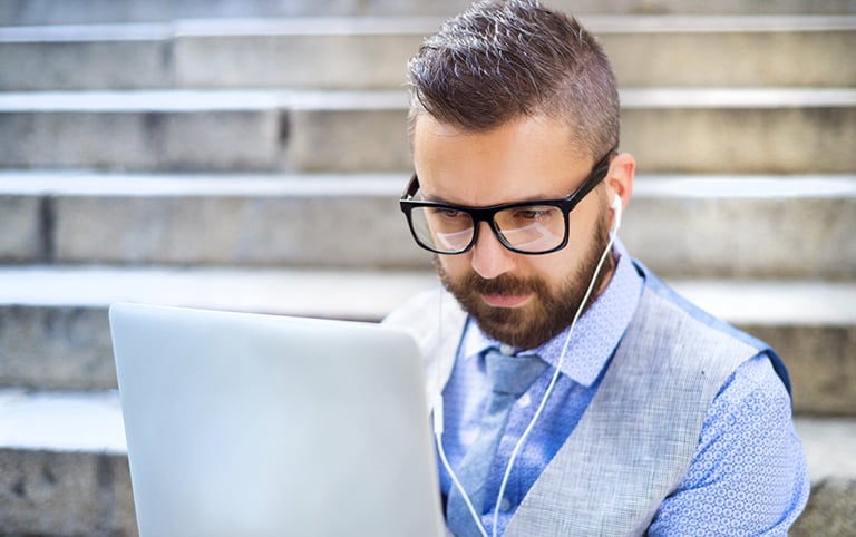 Man with focus working  on laptop